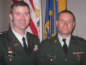 Maj. Robert Edwards, USA (r), executive officer of the Cramer Sabers ROTC Battalion, congratulates Cadet Timothy Marshall, Army ROTC, in May.